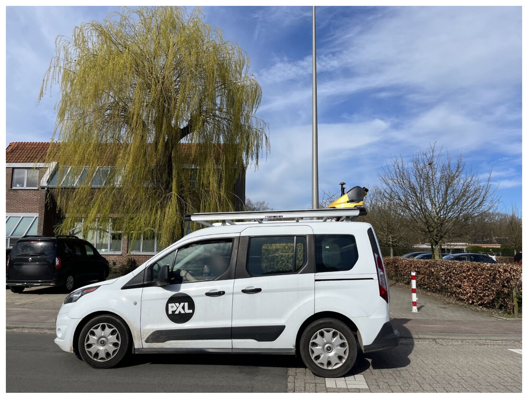 A survey vehicle with a roof-mounted MLS sensor.